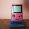 Photo d'une Game Boy Pocket Rose sur son socle, vue de face