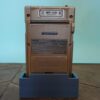 Photo d'une Game Boy Pocket Or sur son socle, vue de dos