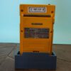 Photo d'une Game Boy Pocket Jaune sur son socle, vue de dos